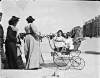 [Two women and one man walking with perambulator and infant on the Parade in Rhyl, North Wales]