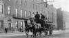 [Carriage drawn by two horses, with driver and male passenger outside 26 Merrion Square]