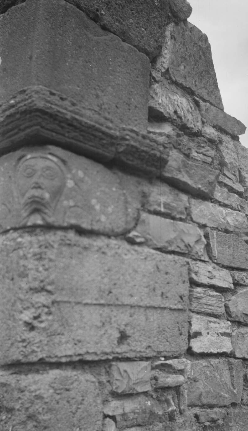 The Abbot's Head, carved on a brown sandstone on a corner of the monastery ruins on Innisfallen Island.