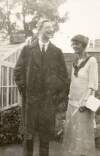 [Éamon De Valera and Countess Markievicz, standing in a garden in front of a house, three quarter-length photograph]