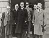 [Éamon De Valera and Seán T. O'Kelly accompanied by four additional unidentified men, standing on steps in front of the entrance to a building]