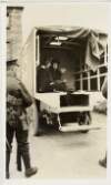[Constance Markievicz seated in a Red Cross ambulance under guard with a nurse beside her]