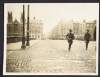 [Two soldiers running along Grattan Bridge, Dublin]