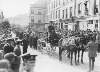 [Lusitania disaster, Cobh, Co. Cork : funeral procession for the victims of the disaster, with coffin drawn by horse and carriage and crowd gathered]
